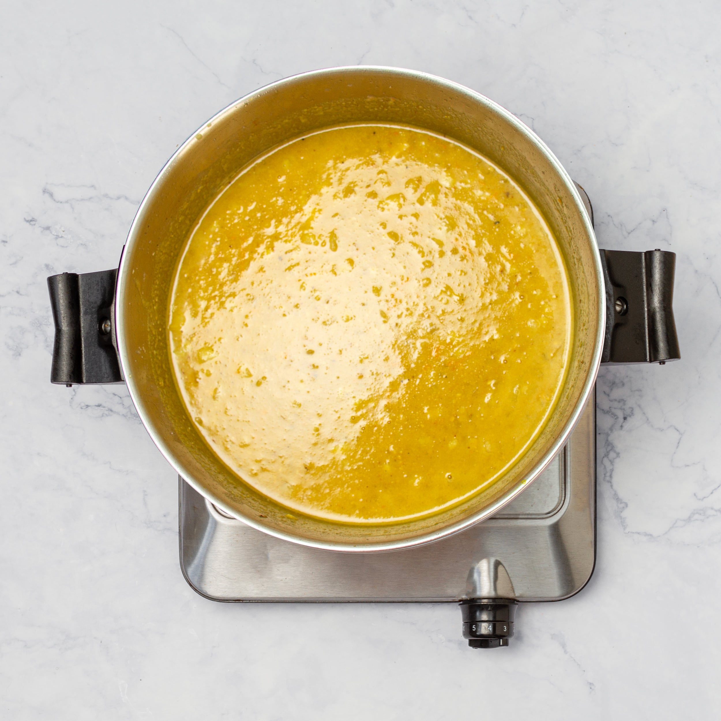 Thick and silky sauce in a pan. 