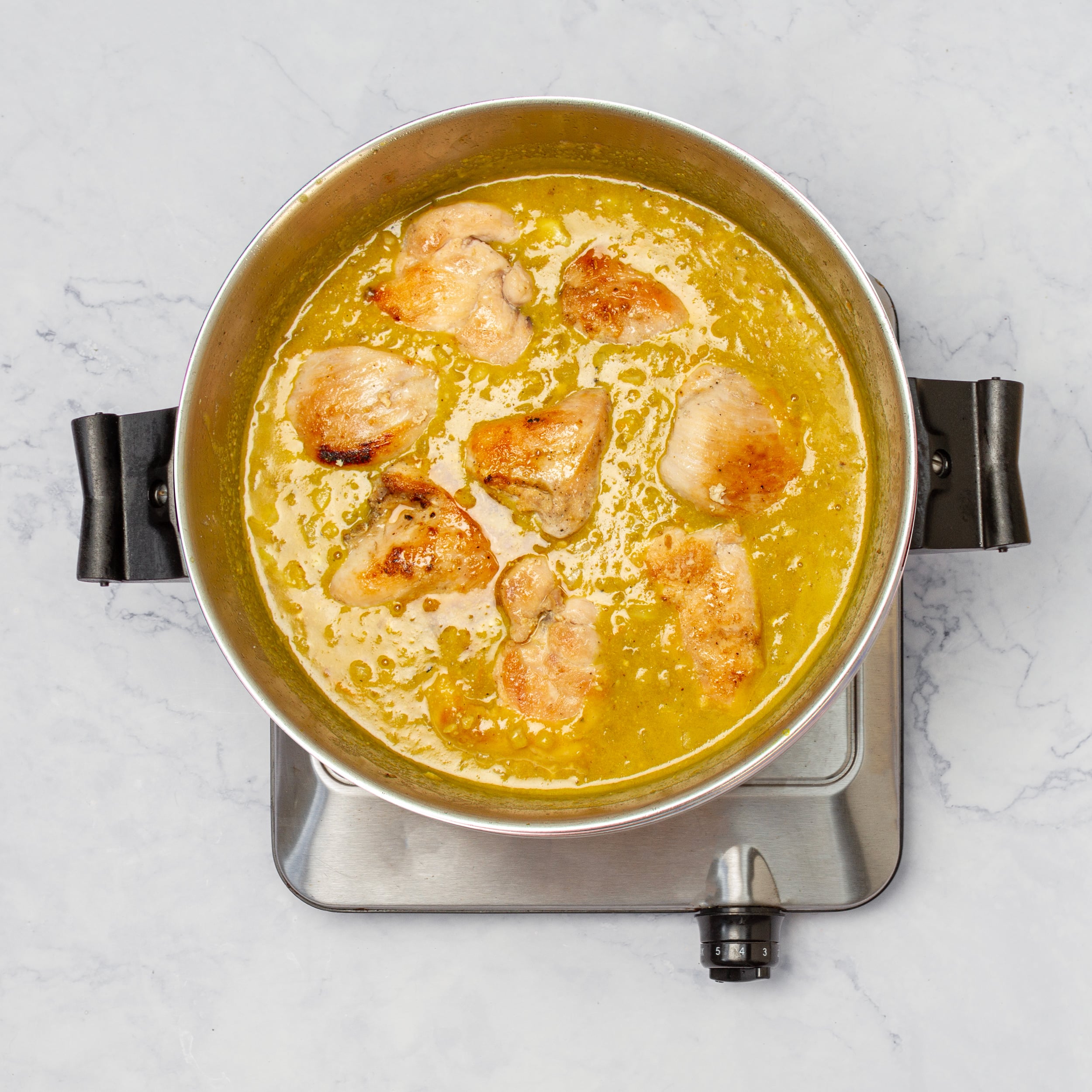 Cooked chicken added to the sauce. 