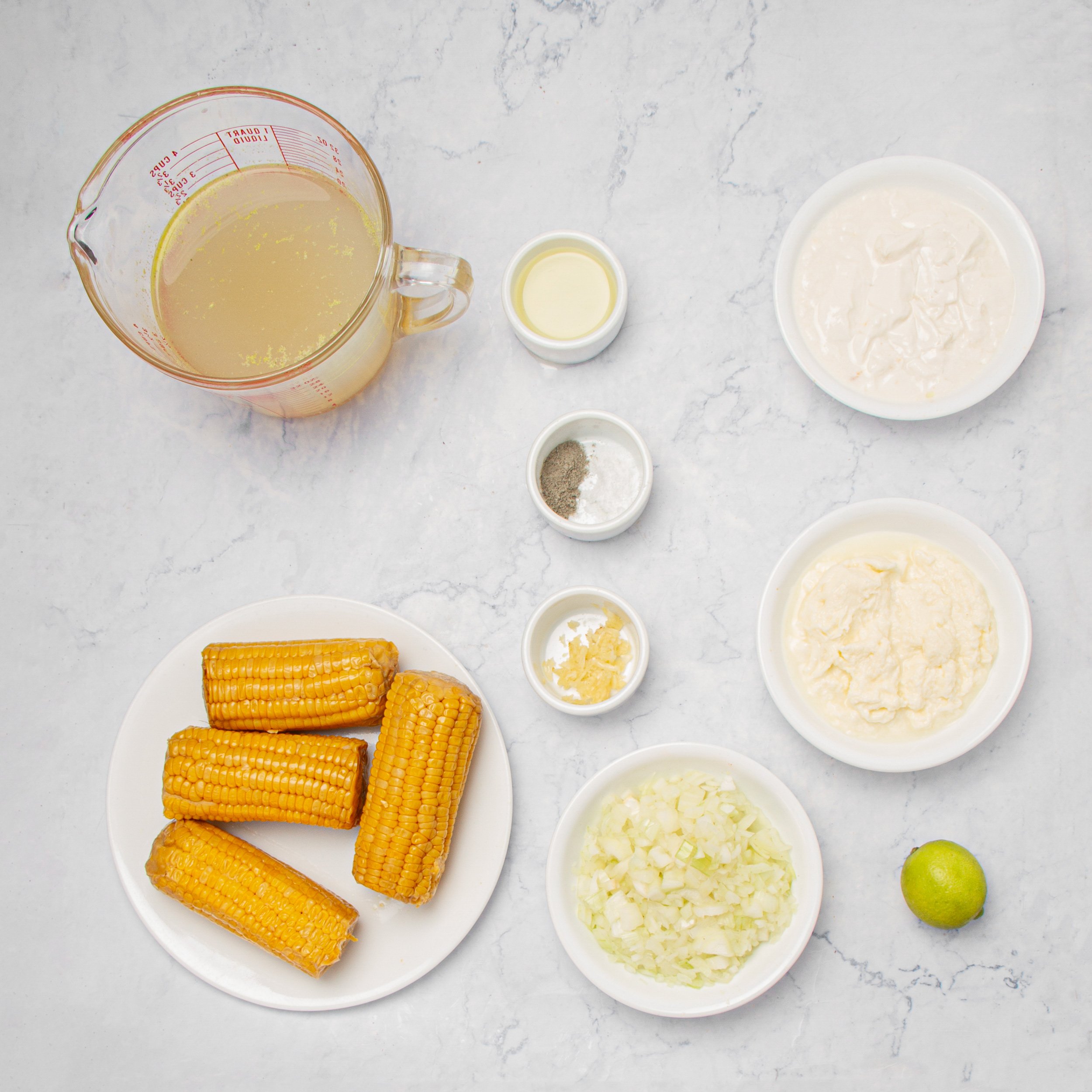 Ingredients for Mexican street corn soup in separate dishes. 