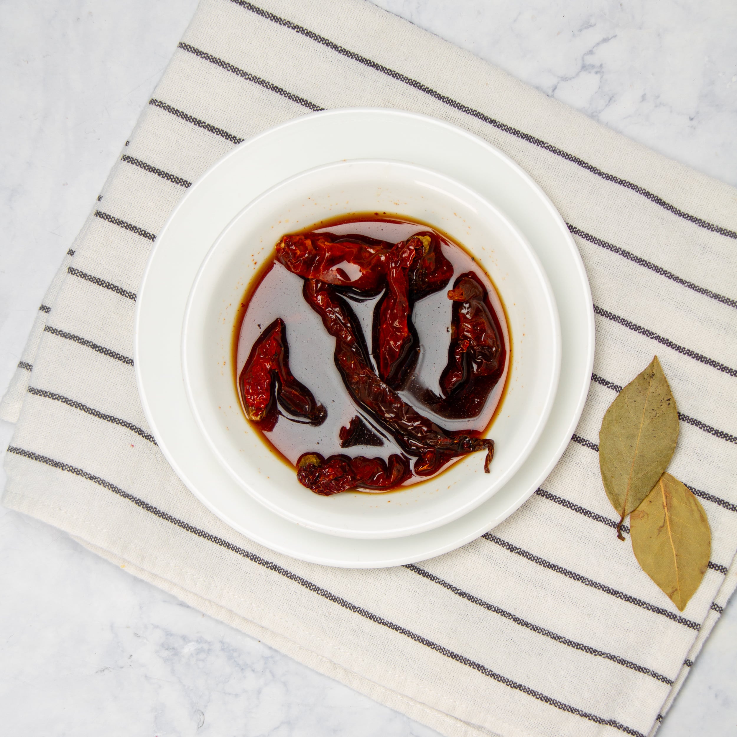 Chili peppers rehydrating in a small bowl. 