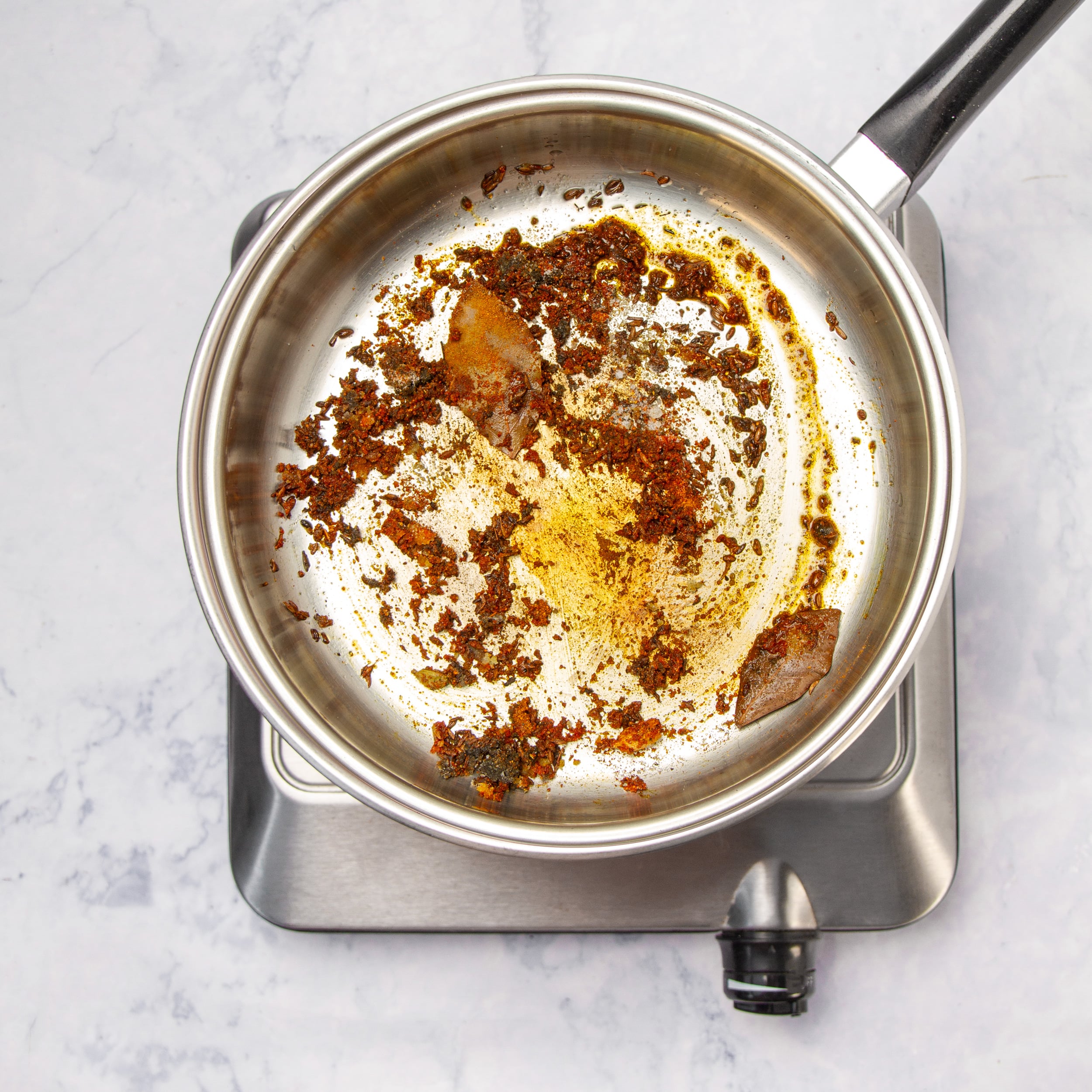Spices toasting in a pan. 