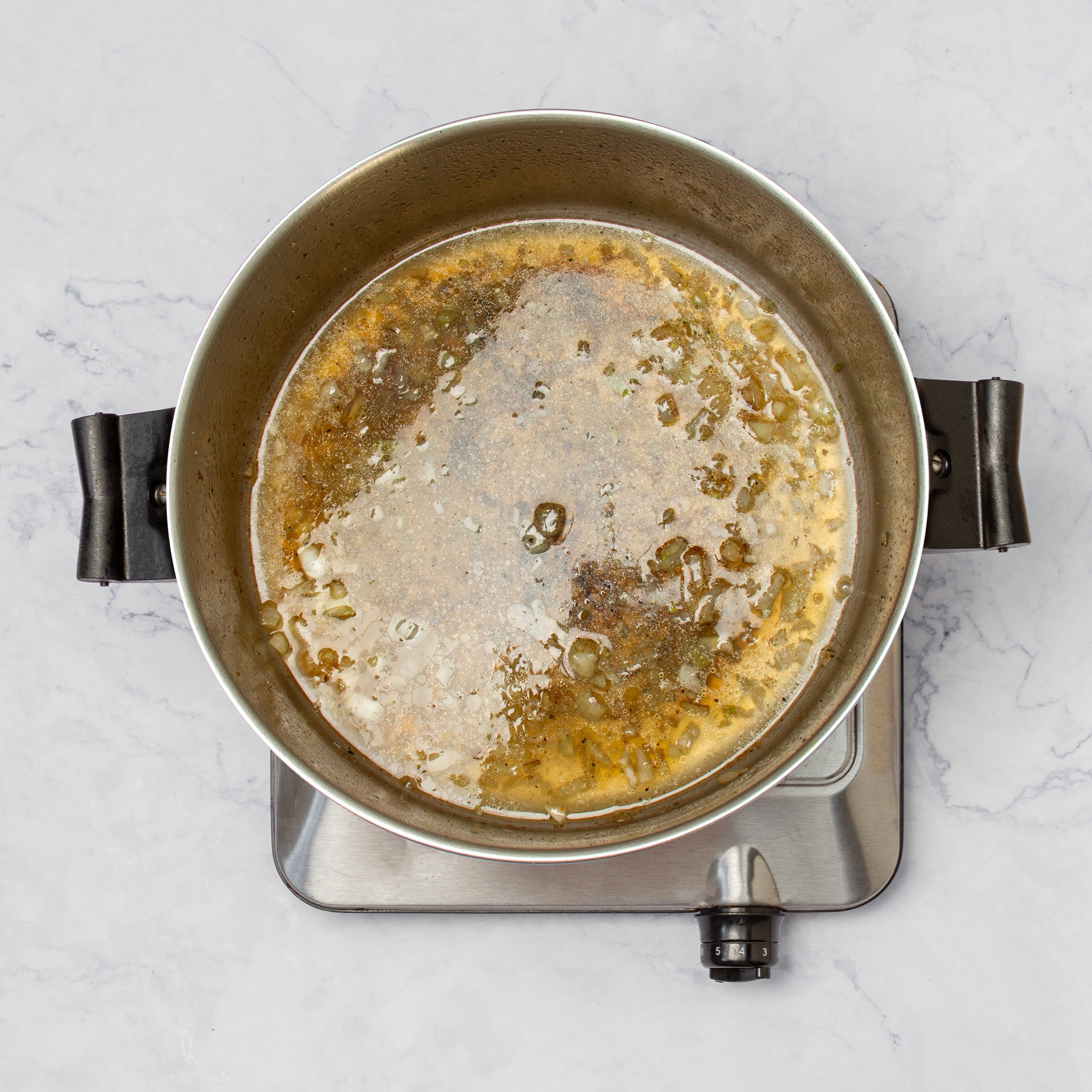 Sauce ingredients cooking in a pan.