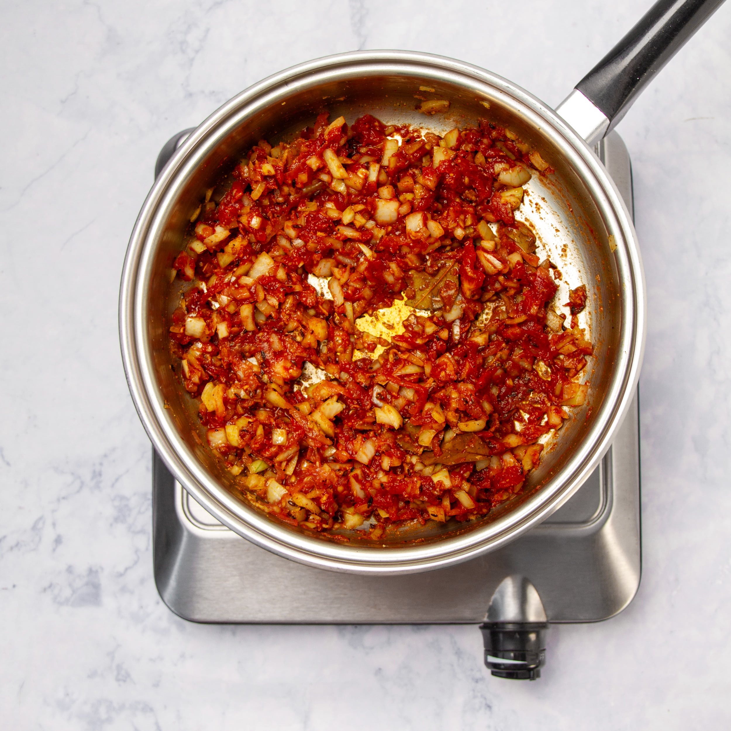 Sauce ingredients cooking in a skillet. 