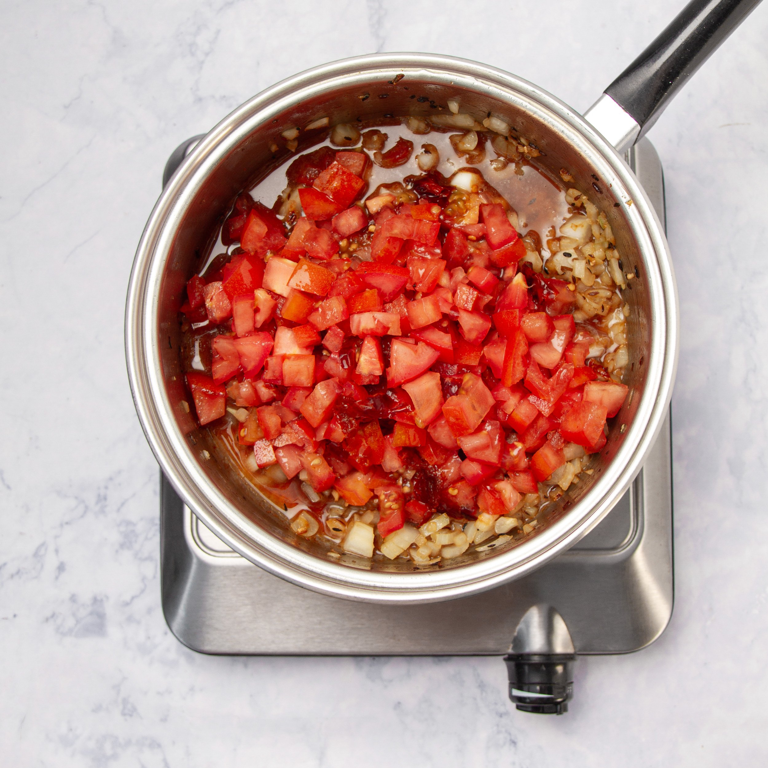 Sauce ingredients cooking in a pan. 